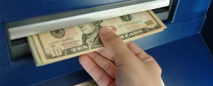 MONEY EXITING THE ATM MACHINE