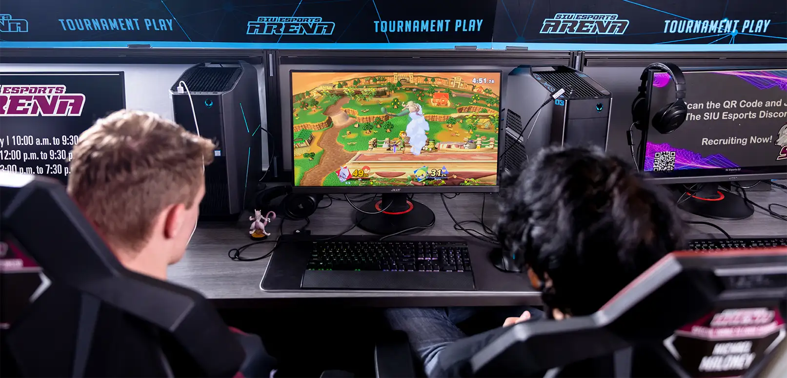 couple of dudes playing some co-op games in the esports arena
