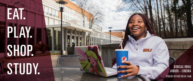 student sitting outside student center