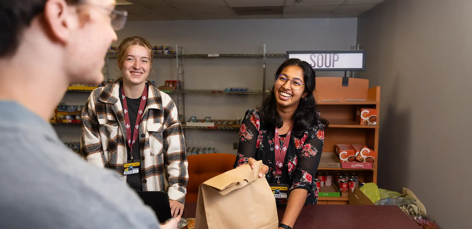 student at the food pantry counter